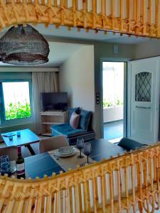 a living room with a table and a couch at V&V Boutique Villa in Argostoli