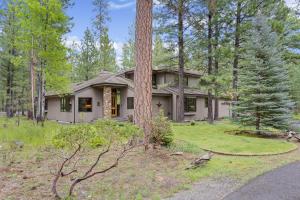 a house in the woods with a tree at Glaze Meadow 376 home in Black Butte Ranch