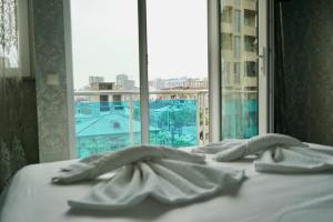 a bed in a room with a window at hotel Vaxx in Batumi