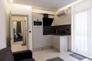 a room with a kitchen and a living room at ADIRAMA Apartments Elegant Apartments Walk to the Beach in Obzor