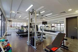 a gym with treadmills and machines in a room at Flat The Time - Brooklin in São Paulo
