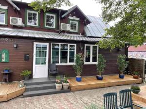 a house with a porch with potted plants on it at Anna Green House in Palanga
