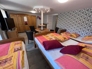 a room with three beds and a tv and a room with at Barka in Ustka
