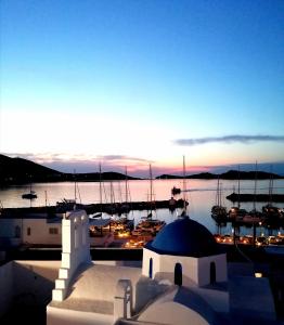 una puesta de sol sobre un puerto deportivo con barcos en el agua en Hotel Galini en Naousa