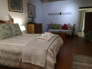 a bedroom with a bed with towels on it at Blou Porselein Guestfarm in Hermon