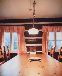 a dining room with a wooden table and chairs at Chata Josef in Rokytnice nad Jizerou