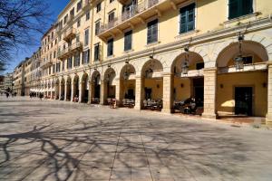 an empty street in front of a large building at Espianade Studio in Corfu Town +15 photos