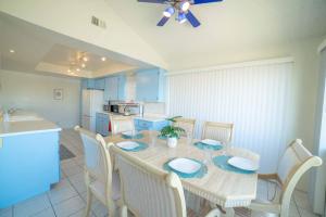 a dining room with a table and chairs and a kitchen at Ocean View / Pool Table / Surfboards / Beach Bikes in Oxnard +17 photos
