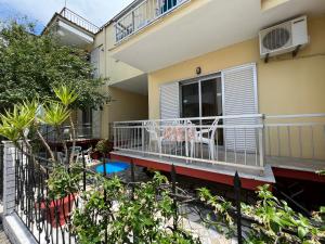 a balcony of a house with a table and chairs at Villa Eleni - Thassos Town in Limenas +70 photos