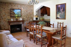 a dining room with a table and chairs and a fireplace at Cortijo Aurelia in Pozo Alcón