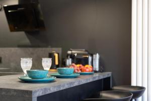 a counter with two blue plates and cups and fruit at Królicza Norka in Lublin