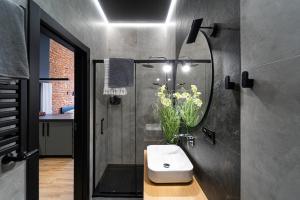 a bathroom with a sink and a shower at Królicza Norka in Lublin