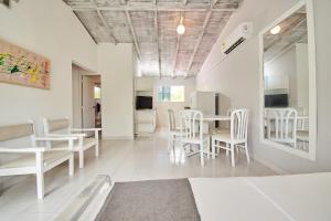 uma sala de estar com cadeiras brancas e uma mesa em Hotel Kpre Coveñas em Coveñas