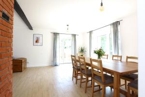 a dining room with a wooden table and chairs at Dobre Miejsce in Międzyzdroje