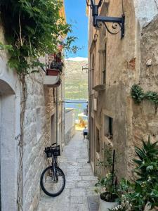 a bike parked on the side of an alley at House Kučija Old town Korčula in Korčula