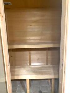 een houten plank in een kast met de deur open bij Private Master suite with Sauna and Bathtub in Fair Oaks