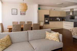 a living room and kitchen with a couch and a table at Panorama apartmán 44-C in Donovaly