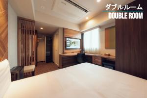a room with a table and a desk and a classroom at Henn na Hotel Sendai Kokubuncho in Sendai