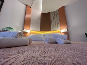 a hotel room with a bed with towels on it at Sinestesia in Polignano a Mare