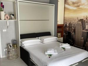 a bedroom with a large bed with towels on it at Studio Flat Policlinico G B Rossi Borgo Roma in Verona