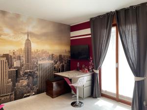 a room with a wall mural of a city at Studio Flat Policlinico G B Rossi Borgo Roma in Verona