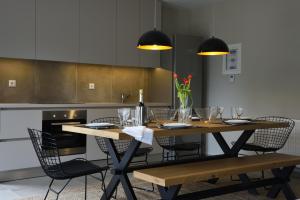 a dining room table with chairs and a kitchen at Amfikleia Home by Relax in Greece in Amfikleia