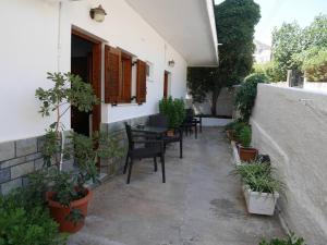 a patio with a table and chairs and plants at Chrysoula’s Convenient Triple Room with Yard in Monemvasia