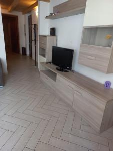 sala de estar con TV de pantalla plana en la pared en Appartamento accogliente/nuovo Livorno en Livorno
