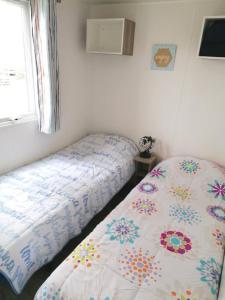 1 dormitorio con 2 camas y ventana en Le balaou en Lit-et-Mixe