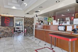 a restaurant with a bar with a table and chairs at Red Roof Inn Needles in Needles