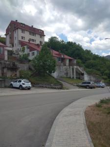 a street with cars parked on the side of a road at Apartman Sofija in Plužine