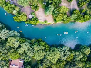 an aerial view of a river and forest at The Faust Hotel in New Braunfels