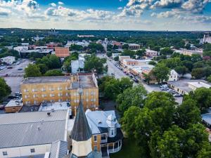 an aerial view of a town with buildings and trees at The Faust Hotel in New Braunfels