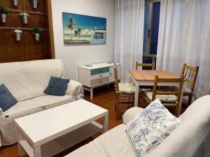 a living room with two couches and a table at Hotel Venezuela in Sanxenxo