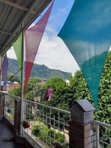 uma vista a partir de uma varanda com guarda-sóis coloridos em MANOA "Lugar de descanso" HABITACION CON VISTA A LA CIUDAD, FRESCO Y VENTILADO em Ibagué
