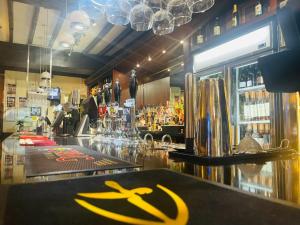 a bar with a yellow sign on the counter at The Bell Hotel Aylesbury in Aylesbury