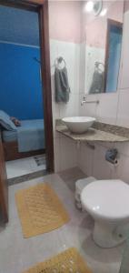 a bathroom with a toilet and a sink and a mirror at Das Marias Hostel in Lagoa Santa