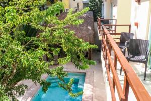 a small pool on the balcony of a house with trees at Tulum Nah in Tulum