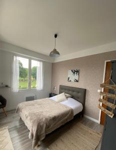 a bedroom with a large bed and a window at LA MAISON DE BARLEST - LOURDES in Barlest