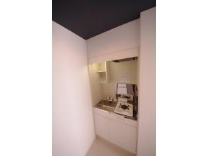 a bathroom with a sink and a mirror at HOTEL APT SESELA - Vacation STAY 12882 in Kanazawa
