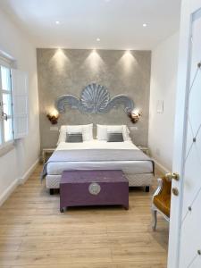 a bedroom with a large bed with a wooden floor at In centro unique rooms in Olbia