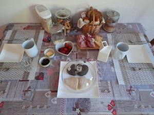 a table with a plate of food on a table at Maso La Marianna Bubble Glamping in Trentino in Sant'Orsola Terme