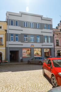 a red car parked in front of a building at Vintage apartmán v centru in Litomyšl