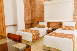 Postel nebo postele na pokoji v ubytování HOTEL OSCAR Tradición