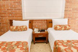 Postel nebo postele na pokoji v ubytování HOTEL OSCAR Tradición