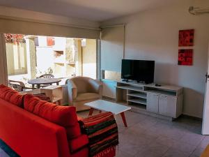 a living room with a couch and a television at Casa Verde in San Rafael
