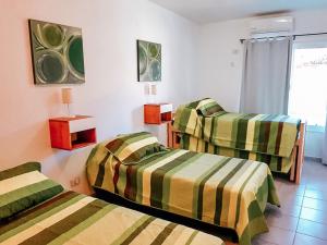 a room with three beds in a room at Casa Verde in San Rafael +17 photos