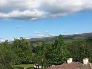 a view of a field with houses and trees at Swan Cabin in Swanlinbar +3 photos