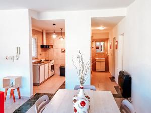 a kitchen and a dining room with a vase on a table at Casa Verde in San Rafael