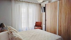 アンテケラにあるAPARTAMENTO CONVENTO ENCARNACIÓNのベッドルーム1室(ベッド1台、椅子、窓付)